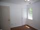 Bedroom with wood flooring and single window at 103 Sara Dr, Nashville, NC 27856