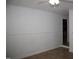 Neutral bedroom with tile flooring and simple wainscoting with an doorway to another room at 103 Sara Dr, Nashville, NC 27856