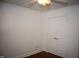 Bedroom with wood-look flooring and double closet doors at 103 Sara Dr, Nashville, NC 27856