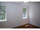 Bedroom featuring hardwood floors and two large windows for natural light at 103 Sara Dr, Nashville, NC 27856