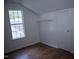 This bedroom has laminate floors, one window, and a door to the right at 103 Sara Dr, Nashville, NC 27856