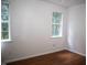 Bedroom features two windows, base trim, and wood floors at 103 Sara Dr, Nashville, NC 27856