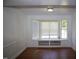 Bright living room with hardwood floors, a large bay window seat, and classic white trim at 103 Sara Dr, Nashville, NC 27856