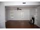 Bright living room featuring hardwood floors, a ceiling fan, and a fireplace at 103 Sara Dr, Nashville, NC 27856