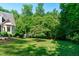 A well-maintained backyard with a small outbuilding nestled among the trees, offering a peaceful retreat at 105 Greenbriar Ct, Chapel Hill, NC 27516