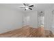 Spacious bedroom featuring hardwood floors, a ceiling fan, with an ensuite bathroom with a soaking tub at 105 Greenbriar Ct, Chapel Hill, NC 27516