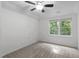 This bedroom features neutral walls, carpet flooring, ceiling fan and a window that offers natural light at 105 Greenbriar Ct, Chapel Hill, NC 27516