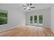 Sunlit bedroom with hardwood flooring and french doors leading to a private balcony, ideal for relaxation and enjoying nature at 105 Greenbriar Ct, Chapel Hill, NC 27516