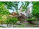 Back exterior view showcases a spacious deck with stairs and access to the home's lower level at 105 Greenbriar Ct, Chapel Hill, NC 27516