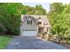 Charming home with a two-car garage, manicured landscaping, and an inviting driveway surrounded by mature trees at 105 Greenbriar Ct, Chapel Hill, NC 27516