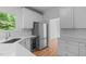 Bright kitchen with stainless steel appliances, white cabinets, and quartz countertops, offering a clean, modern aesthetic at 105 Greenbriar Ct, Chapel Hill, NC 27516