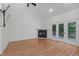 Spacious living room featuring high ceilings, a fireplace, and French doors that flood the area with natural light at 105 Greenbriar Ct, Chapel Hill, NC 27516