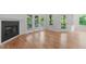 Bright living room featuring beautiful hardwood floors, a fireplace, and French doors leading to an outdoor space at 105 Greenbriar Ct, Chapel Hill, NC 27516