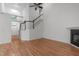 Bright living room featuring a staircase, high ceilings, a fireplace, and wood floors, creating an inviting atmosphere at 105 Greenbriar Ct, Chapel Hill, NC 27516