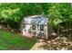 An outbuilding provides additional storage or workspace nestled within a serene, wooded setting at 105 Greenbriar Ct, Chapel Hill, NC 27516