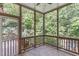 This screened-in porch features tile floors, wooden railings and beautiful views of the surrounding trees at 105 Greenbriar Ct, Chapel Hill, NC 27516