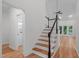 Elegant staircase with hardwood steps and white risers, connecting the different levels of the home at 105 Greenbriar Ct, Chapel Hill, NC 27516