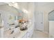 Well-lit bathroom featuring double vanity, large mirror, and separate tub and shower at 107 Roan Dr, Garner, NC 27529