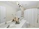 Clean bathroom featuring double sinks, framed mirror, and shower with white curtain at 107 Roan Dr, Garner, NC 27529