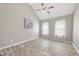 Bright bedroom with vaulted ceiling, fan, and two windows providing ample natural light at 107 Roan Dr, Garner, NC 27529