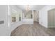 Inviting dining area with large windows and a view into a living space with a staircase at 107 Roan Dr, Garner, NC 27529