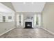 Inviting living room with a fireplace, neutral tones, and views to a bright kitchen at 107 Roan Dr, Garner, NC 27529