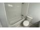 Clean bathroom with white tile and a bathtub/shower combo at 108 Shadowbrook Dr, Hillsborough, NC 27278