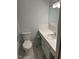 Bathroom featuring a toilet and vanity with a white vessel sink at 108 Shadowbrook Dr, Hillsborough, NC 27278