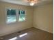 Bedroom featuring neutral walls, plush carpeting, a ceiling fan and a window offering views of the outdoors at 108 Shadowbrook Dr, Hillsborough, NC 27278