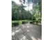 Large wooden deck with decorative railing overlooking the lush backyard at 108 Shadowbrook Dr, Hillsborough, NC 27278