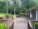 Large wooden deck overlooking the backyard with lush trees at 108 Shadowbrook Dr, Hillsborough, NC 27278