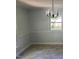 Cozy dining room area features neutral paint, chair rail, window with outside view, and chandelier style lighting at 108 Shadowbrook Dr, Hillsborough, NC 27278