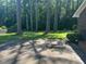 Driveway leading to a brick home surrounded by tall trees at 108 Shadowbrook Dr, Hillsborough, NC 27278
