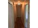 Hallway featuring hardwood flooring and neutral walls, connecting the various rooms in the home at 108 Shadowbrook Dr, Hillsborough, NC 27278