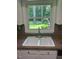 Close-up on kitchen with white cabinets and a double bowl sink that features a view of the outdoors at 108 Shadowbrook Dr, Hillsborough, NC 27278