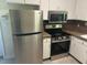 Bright kitchen featuring stainless steel appliances and white cabinets, providing a clean and modern feel at 108 Shadowbrook Dr, Hillsborough, NC 27278
