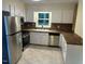 Bright kitchen featuring stainless steel appliances, white cabinets, and contrasting countertops with backsplash at 108 Shadowbrook Dr, Hillsborough, NC 27278