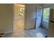 View of the kitchen with tile floors, showcasing a dining area with a view, and an access door to the outdoors at 108 Shadowbrook Dr, Hillsborough, NC 27278