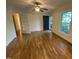 Inviting living room boasts beautiful hardwood floors, ceiling fan, and access to several rooms throughout the home at 108 Shadowbrook Dr, Hillsborough, NC 27278