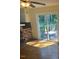 Living room featuring hardwood floors, a brick fireplace, ceiling fan, and sliding glass doors to deck at 108 Shadowbrook Dr, Hillsborough, NC 27278