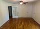 Living room featuring hardwood flooring, ceiling fan, and view of front yard, offering versatility in decor and styling at 108 Shadowbrook Dr, Hillsborough, NC 27278