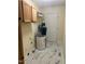 Utility room with a water heater, cabinets, and tile floors at 108 Shadowbrook Dr, Hillsborough, NC 27278