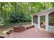 View of the back deck with a screened-in porch overlooking the serene wooded backyard at 10836 Wilmore Dr, Raleigh, NC 27614