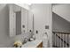 Bathroom featuring a sink with large mirror, and staircase view at 10836 Wilmore Dr, Raleigh, NC 27614