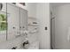 Clean bathroom featuring modern vanity, glass shelving, and updated fixtures at 10836 Wilmore Dr, Raleigh, NC 27614