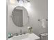 Bathroom with a modern sink and a round mirror above it at 10836 Wilmore Dr, Raleigh, NC 27614