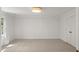 Bright bedroom with neutral carpet, closet, and natural light from large window at 10836 Wilmore Dr, Raleigh, NC 27614