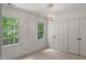 Bedroom with two windows for natural light and classic chandelier at 10836 Wilmore Dr, Raleigh, NC 27614