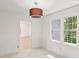 Bedroom featuring carpet floors, a large window, and modern lighting at 10836 Wilmore Dr, Raleigh, NC 27614