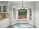 Bright breakfast nook with white cabinets and a bay window with backyard view at 10836 Wilmore Dr, Raleigh, NC 27614